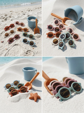 Load image into Gallery viewer, Baby sunglasses with UV400 protection arranged on beach sand