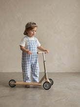 Load image into Gallery viewer, Side view of child wearing blue gingham dungarees with embroidered pigeon t-shirt
