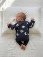 Load image into Gallery viewer, Sleeping baby wearing the Ada Baby Celestial Knit Jumper in soft 100% cotton with a muslin moon comforter on white linen bedding.