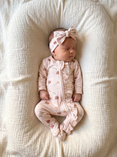 Load image into Gallery viewer, Newborn baby wearing a pink floral organic cotton sleepsuit with matching headband