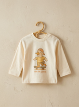 Load image into Gallery viewer, Organic cotton kids long-sleeve t-shirt with silly goose skateboard illustration hanging on wooden hanger against neutral wall