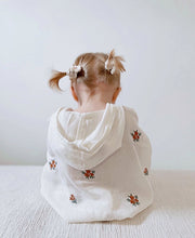 Load image into Gallery viewer, toddler girl wearing floral muslin baby poncho – lightweight and breathable design