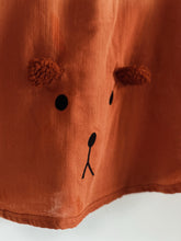 Load image into Gallery viewer, close-up of muslin poncho fabric with bear face embroidery – soft texture detail
