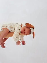 Load image into Gallery viewer, baby resting peacefully in soft muslin puppy-themed outfit