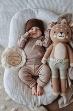 Load image into Gallery viewer, newborn resting peacefully in two-piece beige baby set with rainbow motif
