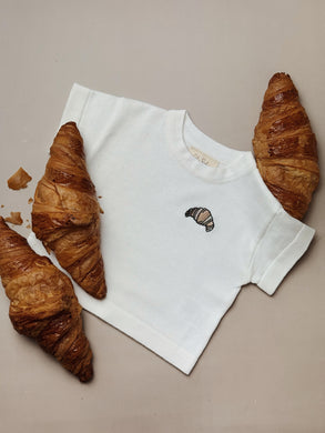 off-white cotton baby t-shirt with embroidered croissant – playful summer top