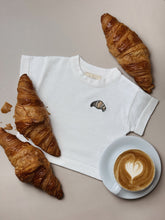 Load image into Gallery viewer, flat lay of croissant t-shirt with real croissants – bakery-inspired baby outfit
