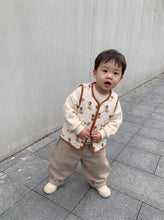Load image into Gallery viewer, Toddler wearing cream organic cotton quilted dachshund gilet with rust binding and button fastening
