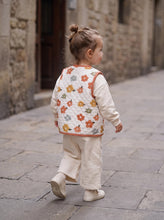 Load image into Gallery viewer, Back view of toddler wearing organic cotton quilted floral gilet with retro flower print
