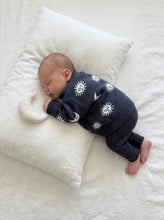 Load image into Gallery viewer, Sleeping baby styled in the oversized Celestial Knit Jumper made from 100% cotton beside a soft muslin moon comforter.

