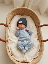 Load image into Gallery viewer, Baby wearing a dusty blue cotton knit beanie featuring a whale patch and soft folded ribbed cuff.
