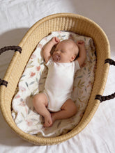 Load image into Gallery viewer, Newborn baby lying in a Moses basket on a floral 4-layer muslin baby blanket
