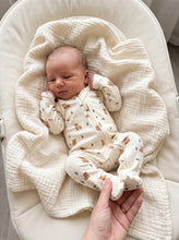Load image into Gallery viewer, Newborn baby wearing a Highland cow print footed zip-up onesie
