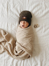 Load image into Gallery viewer, Newborn baby wearing a khaki cotton knit beanie with Highland cow patch, soft breathable winter hat.
