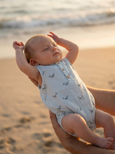 Load image into Gallery viewer, Baby wearing organic cotton romper on the beach
