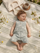 Load image into Gallery viewer, Baby wearing sage palm print organic cotton muslin romper lying on striped blanket
